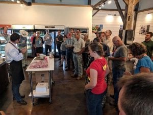 Attendees of the Profitable Farm Workshop learning about porchetta at Marksbury Farm in Kentucky.